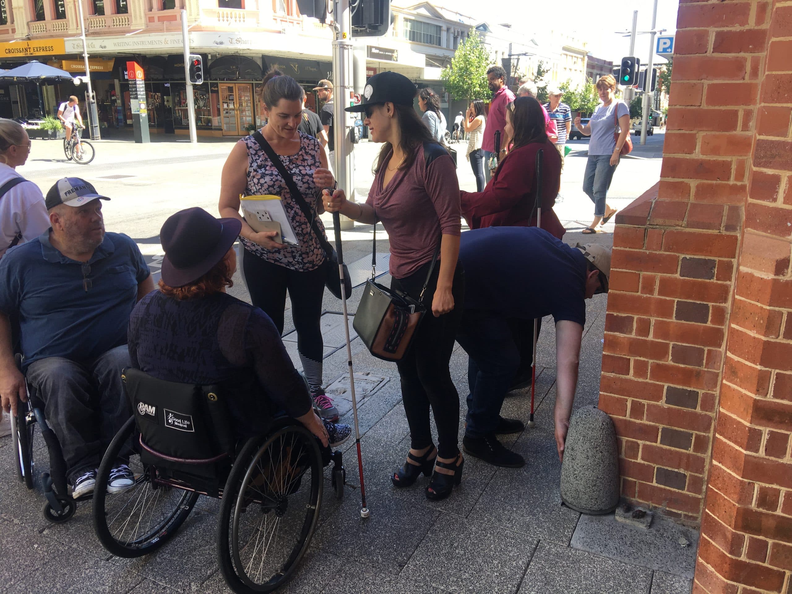 Participants on an accessible scavenger hunt outside Perth Town Hall, with some standing and others using wheelchairs.