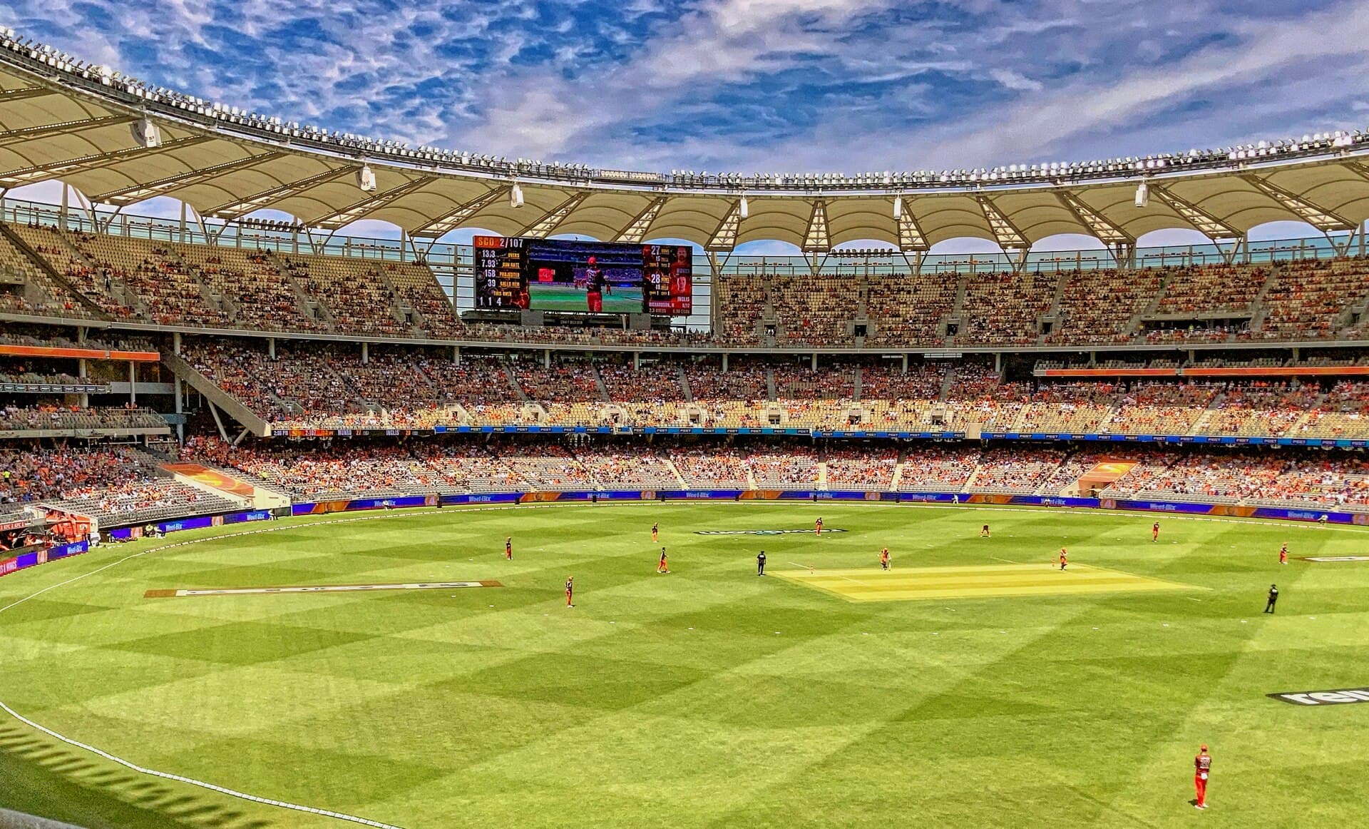 Inside Optus Stadium with a full crowd under the roof canopy on a match day